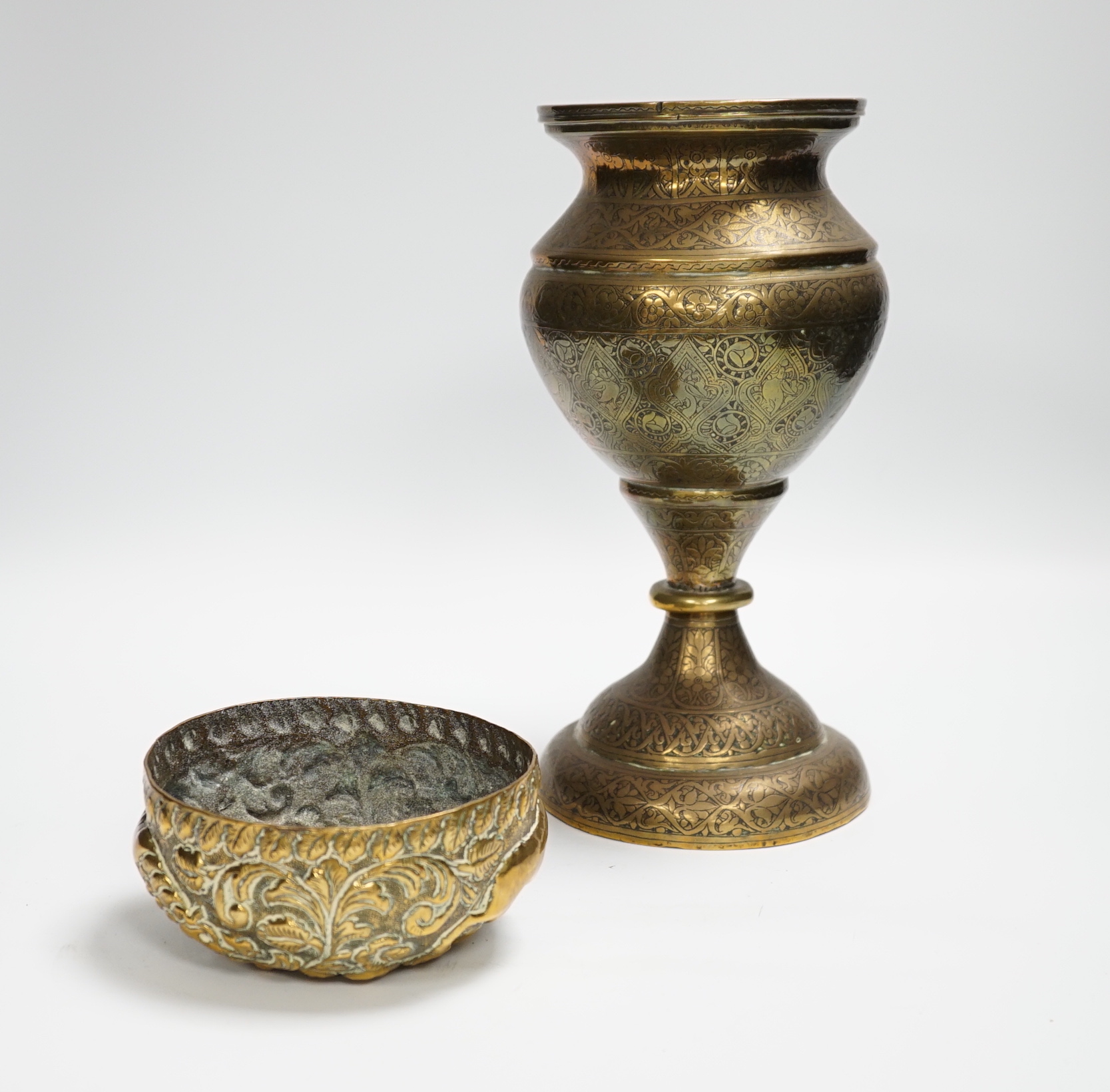 A Persian Qajar engraved brass vase and an Indian repousse brass bowl, largest 25cm high